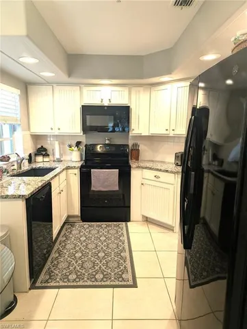 a kitchen with a sink stove and refrigerator