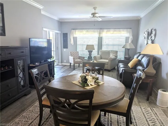 a view of a dining room with furniture window and wooden floor