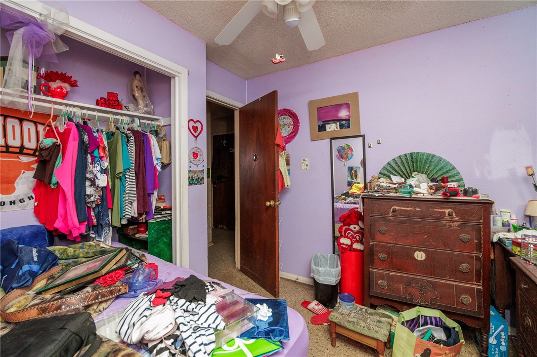 1007 Ross Street George West, TX 78022 - Photo 16 of 24 a bed room with a bed a couch and dresser