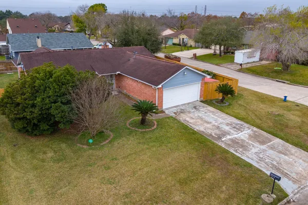an aerial view of a house with a garden and yard