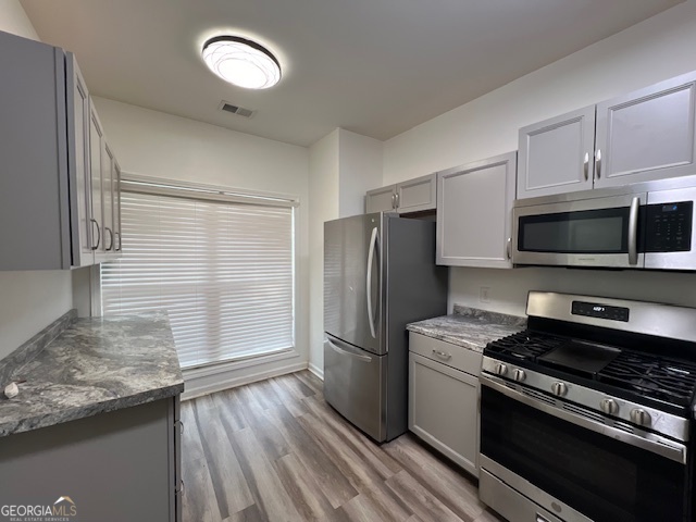 2026 Austin Park Circle Decatur, GA 30032 - Photo 15 of 32 a kitchen with stainless steel appliances granite countertop a refrigerator and a stove top oven