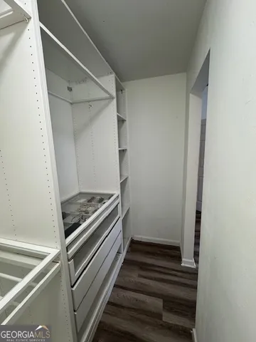 a view of a room with wooden floor