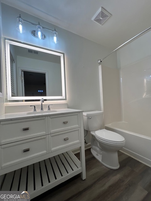 2026 Austin Park Circle Decatur, GA 30032 - Photo 28 of 32 a bathroom with a toilet a sink and mirror
