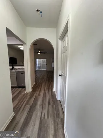 a view of a hallway view with wooden floor and staircase