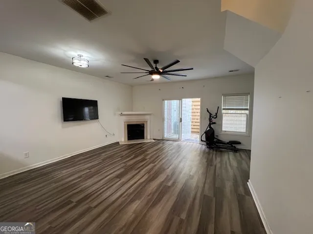 wooden floor that has a fireplace in it