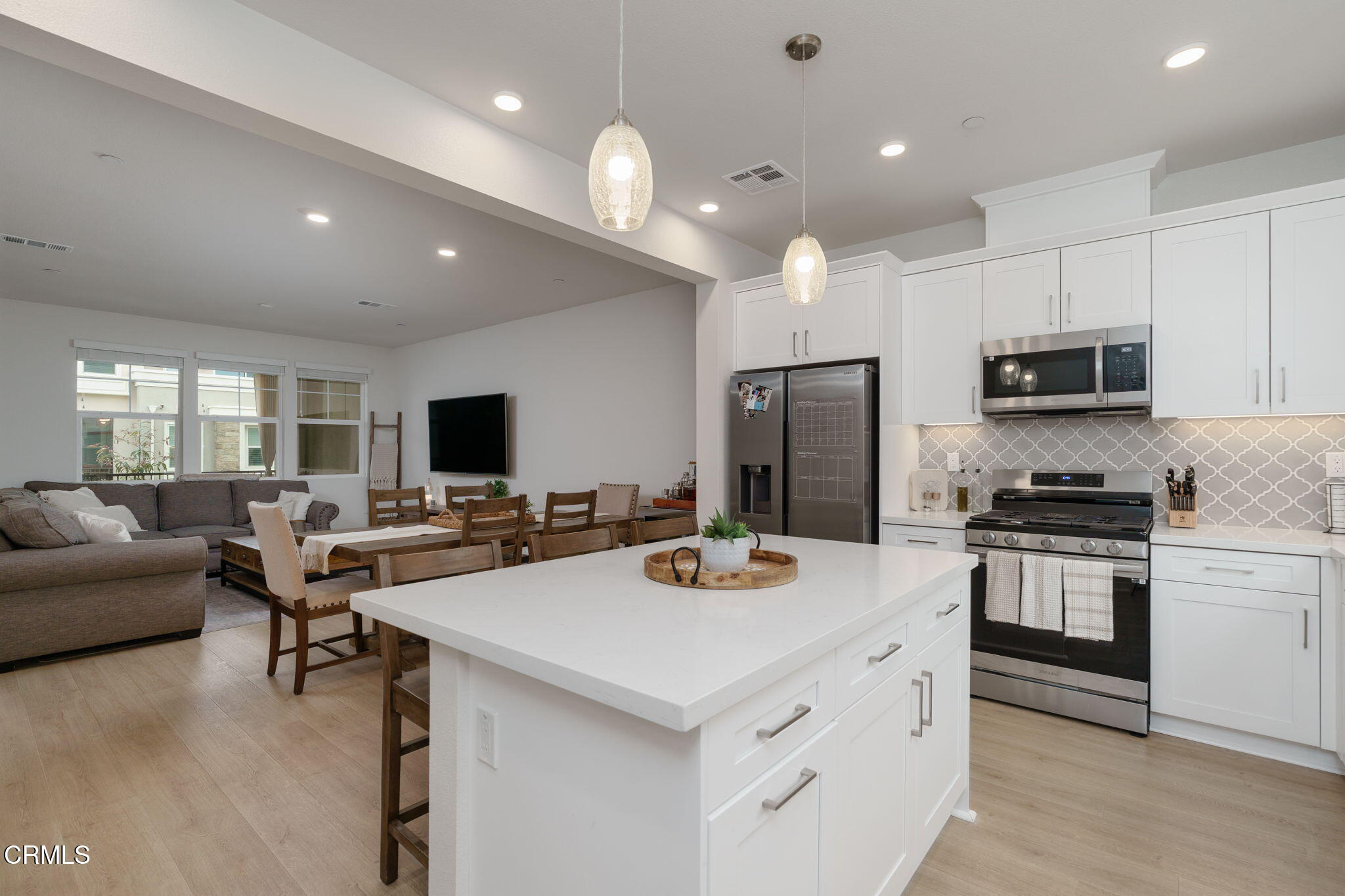 751 Winchester Drive Oxnard, CA 93036 - Photo 16 of 33 a kitchen that has a lot of cabinets a sink and a stove top oven with wooden floor