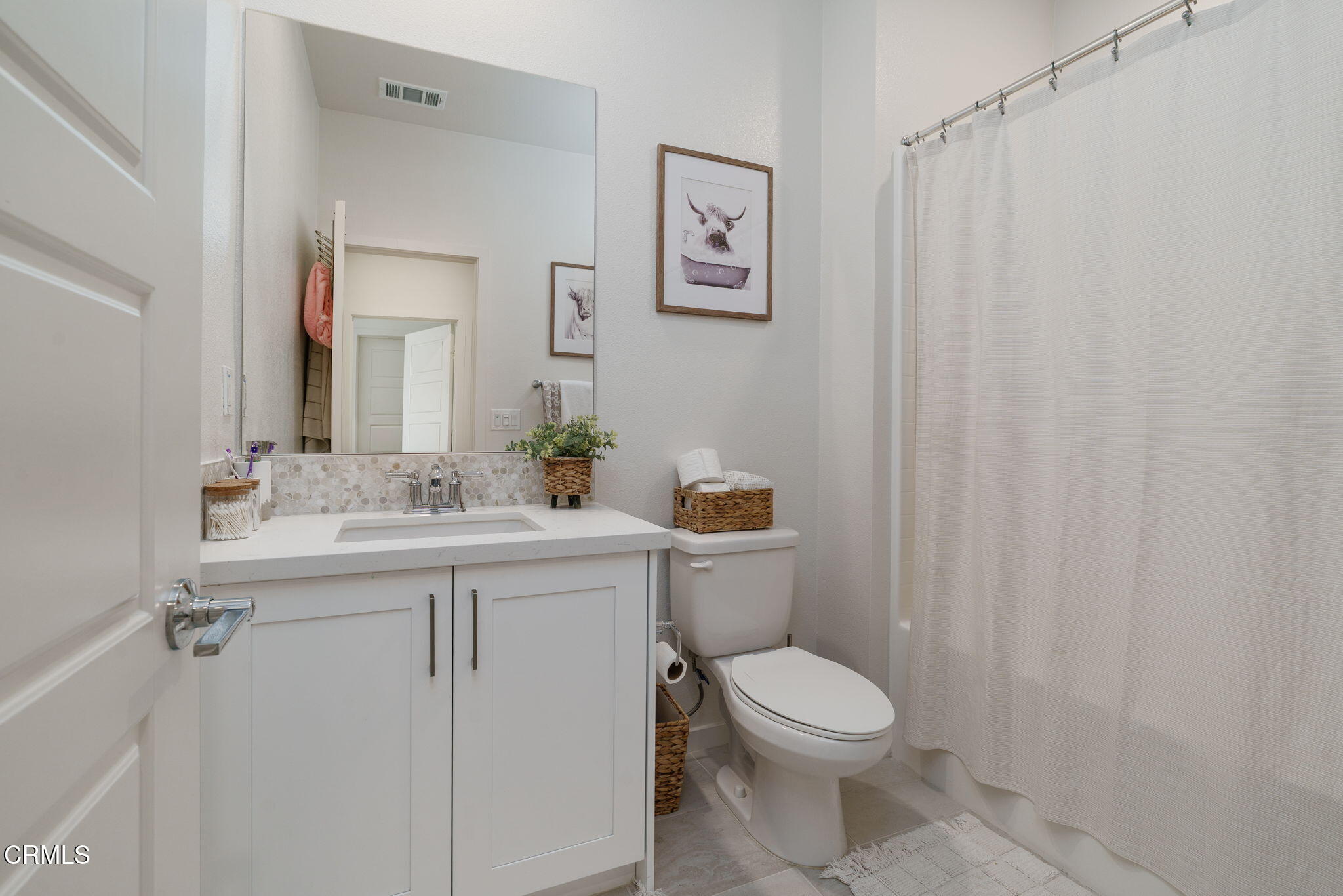 751 Winchester Drive Oxnard, CA 93036 - Photo 27 of 33 a bathroom with a toilet sink vanity and mirror
