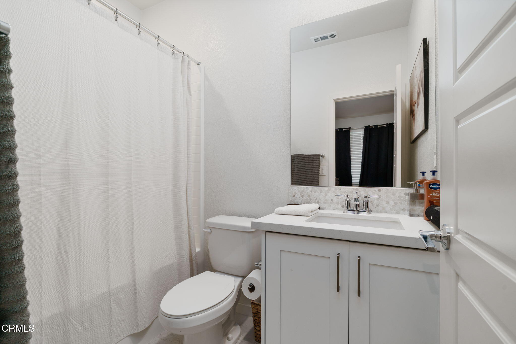 751 Winchester Drive Oxnard, CA 93036 - Photo 6 of 33 a bathroom with a toilet sink vanity and mirror