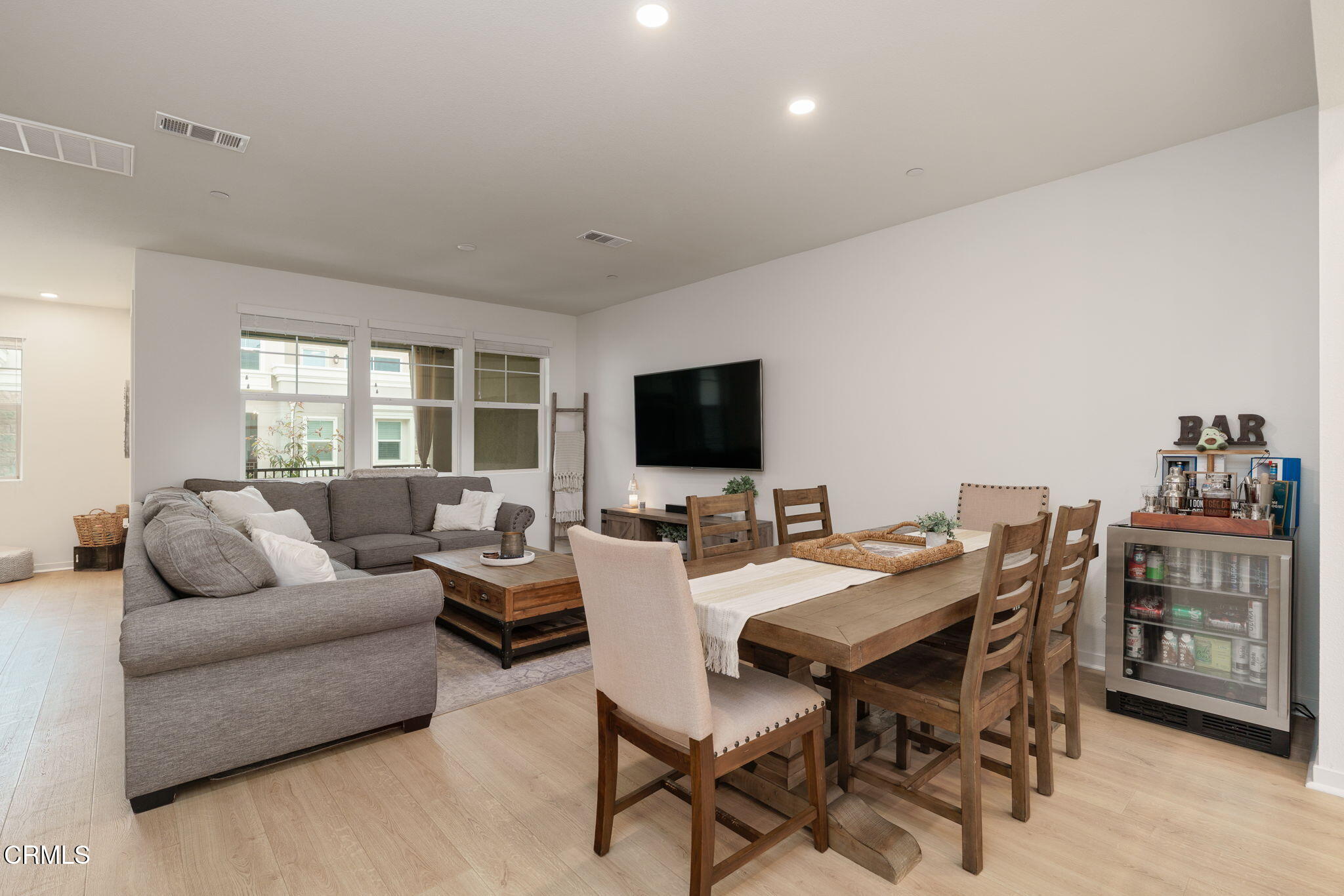 751 Winchester Drive Oxnard, CA 93036 - Photo 10 of 33 a living room with furniture a flat screen tv and a large window