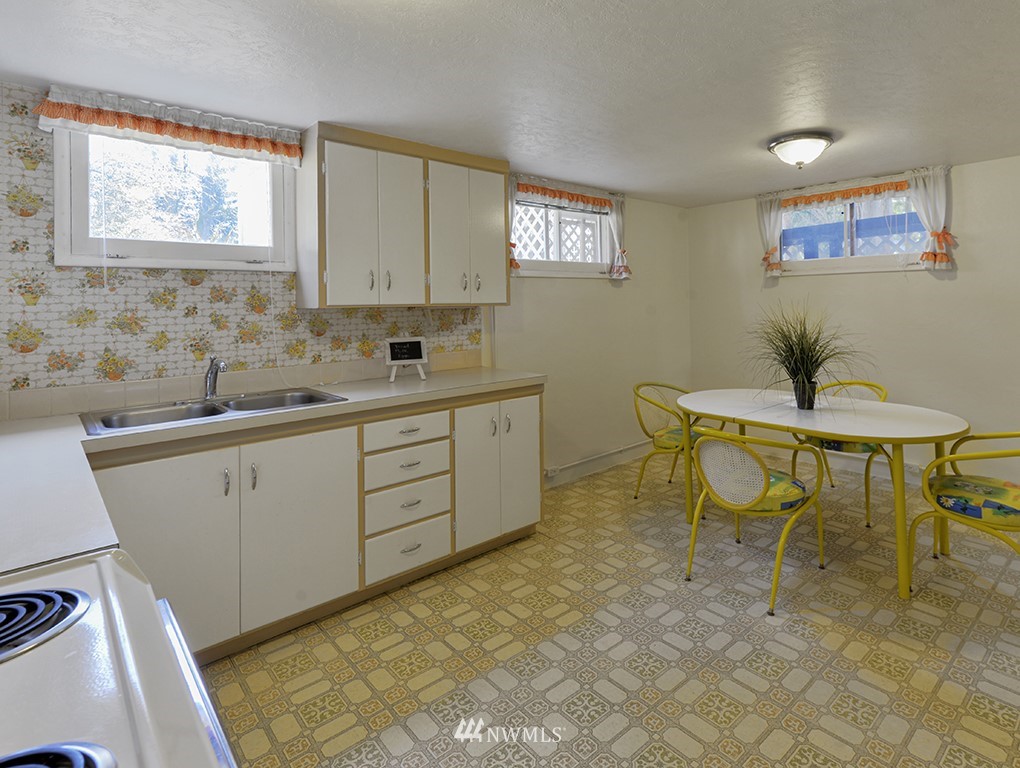 15256 Southeast 116th Street Renton, WA 98059 - Photo 11 of 38 a kitchen with a sink cabinets and window