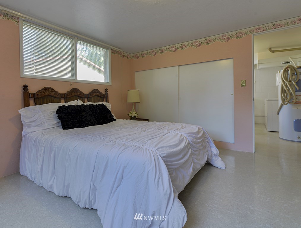 15256 Southeast 116th Street Renton, WA 98059 - Photo 14 of 38 a bedroom with a bed and a window