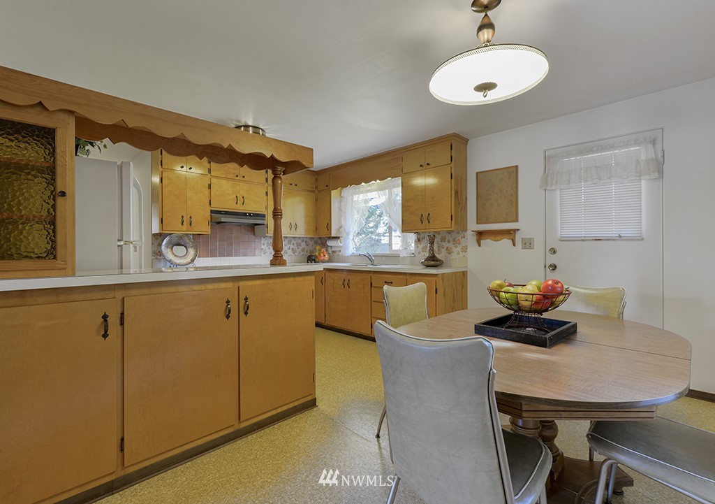 15256 Southeast 116th Street Renton, WA 98059 - Photo 27 of 38 a kitchen with a table chairs and white cabinets