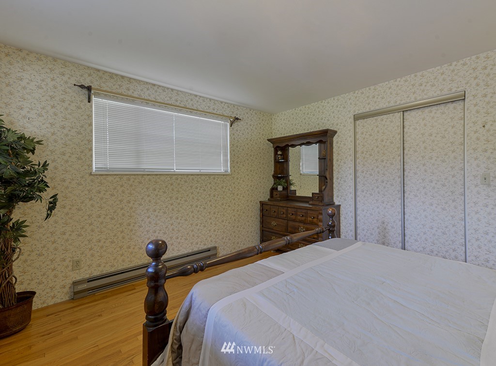 15256 Southeast 116th Street Renton, WA 98059 - Photo 30 of 38 a bedroom with a bed and a flat tv screen on a dresser