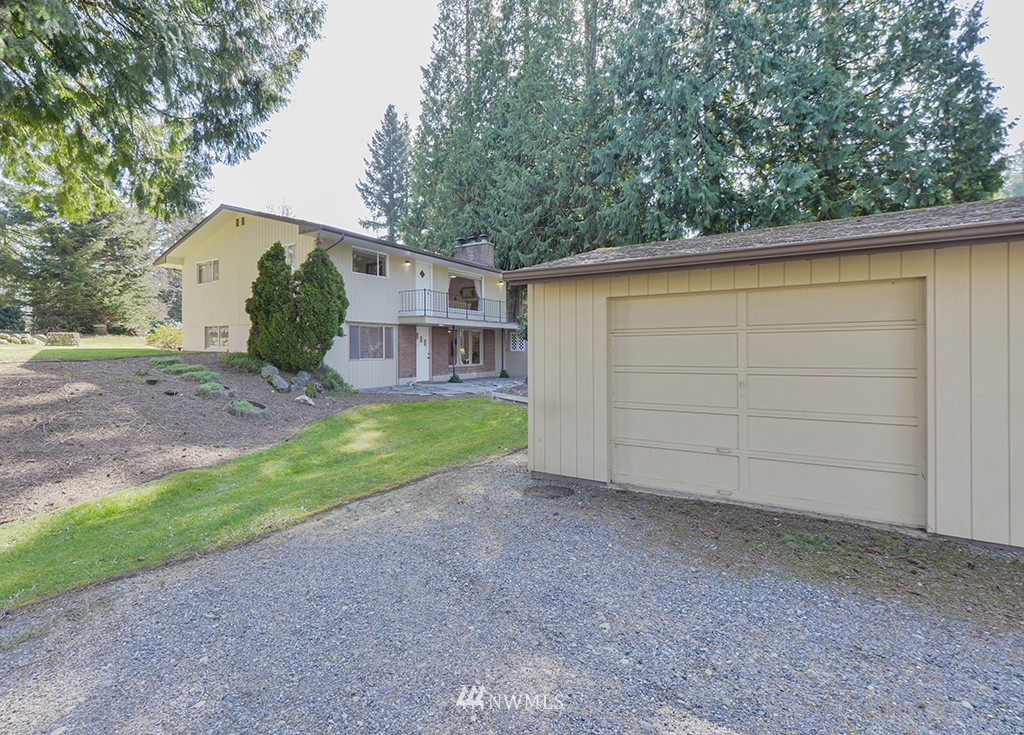 15256 Southeast 116th Street Renton, WA 98059 - Photo 36 of 38 a view of a house with a backyard and a tree
