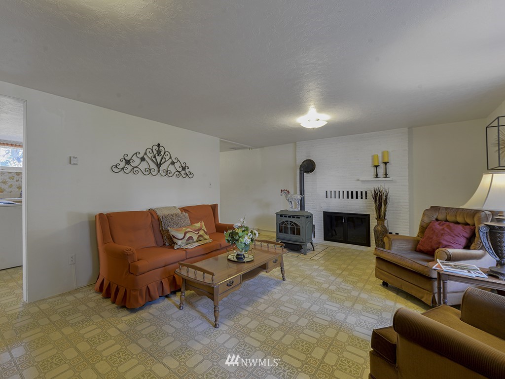 15256 Southeast 116th Street Renton, WA 98059 - Photo 8 of 38 a living room with furniture and a fireplace
