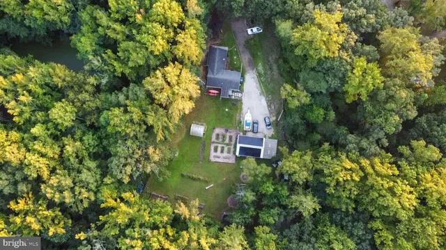 an aerial view of a house with a yard and garden