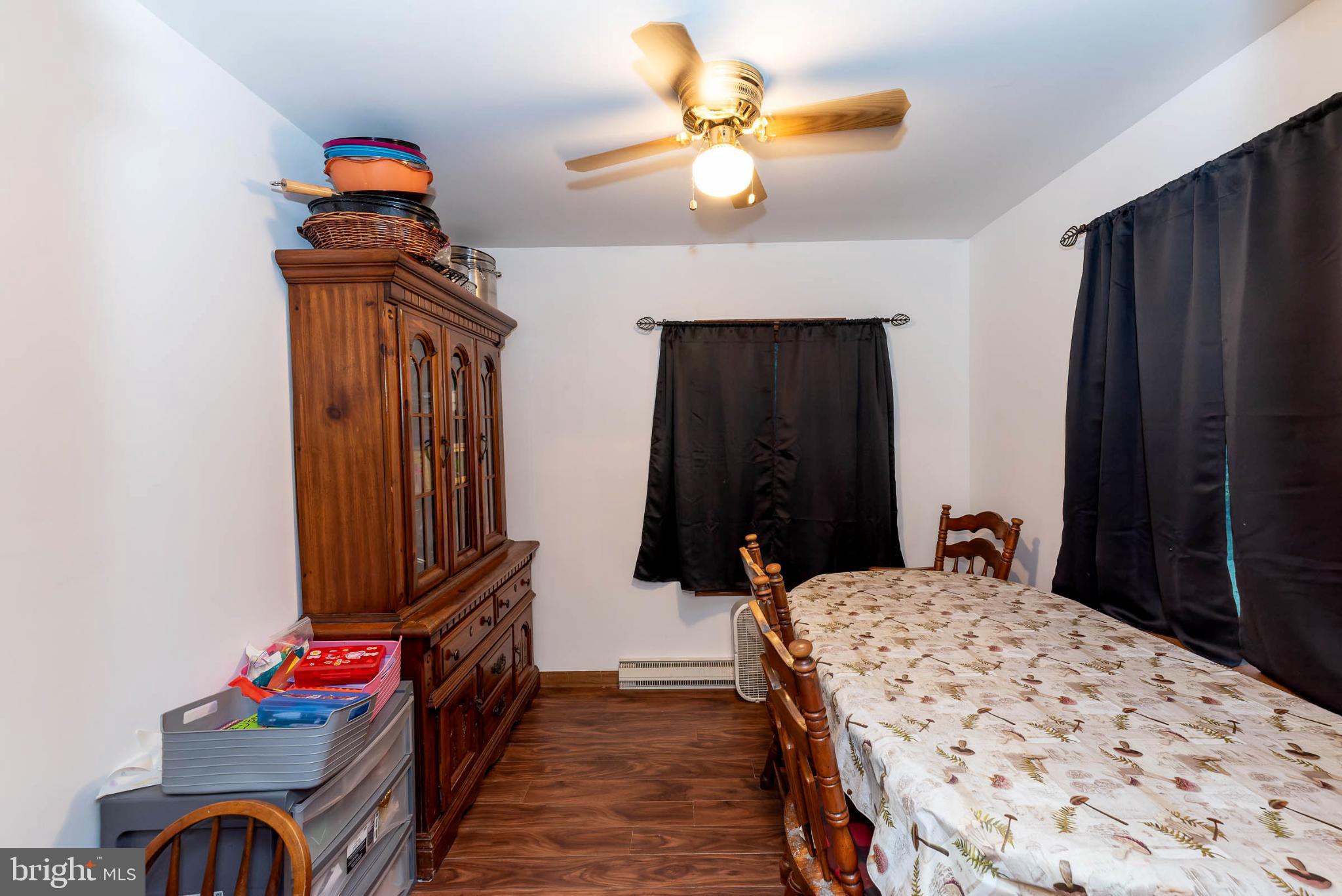 550 Quinton-Marlboro Road Bridgeton, NJ 08302 - Photo 8 of 30 a bedroom with a bed and a chandelier