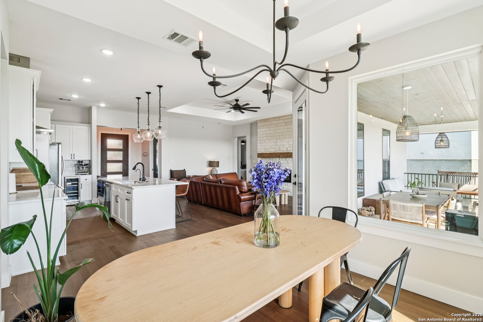 517 Preston Trail Boerne, TX 78006 - Photo 11 of 40 a view of a dining room and livingroom with furniture wooden floor a chandelier