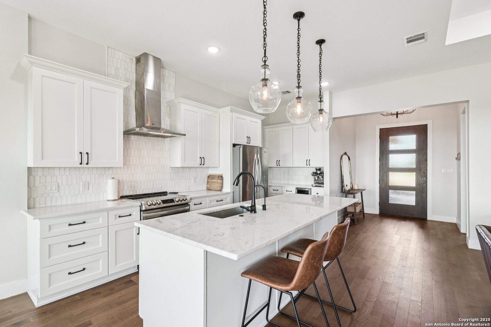 517 Preston Trail Boerne, TX 78006 - Photo 15 of 40 a kitchen that has a lot of cabinets in it and wooden floors