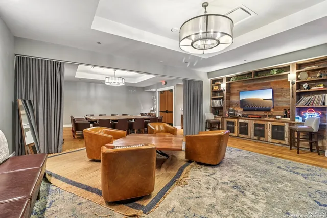 a view of a patio with couches potted plants and a table