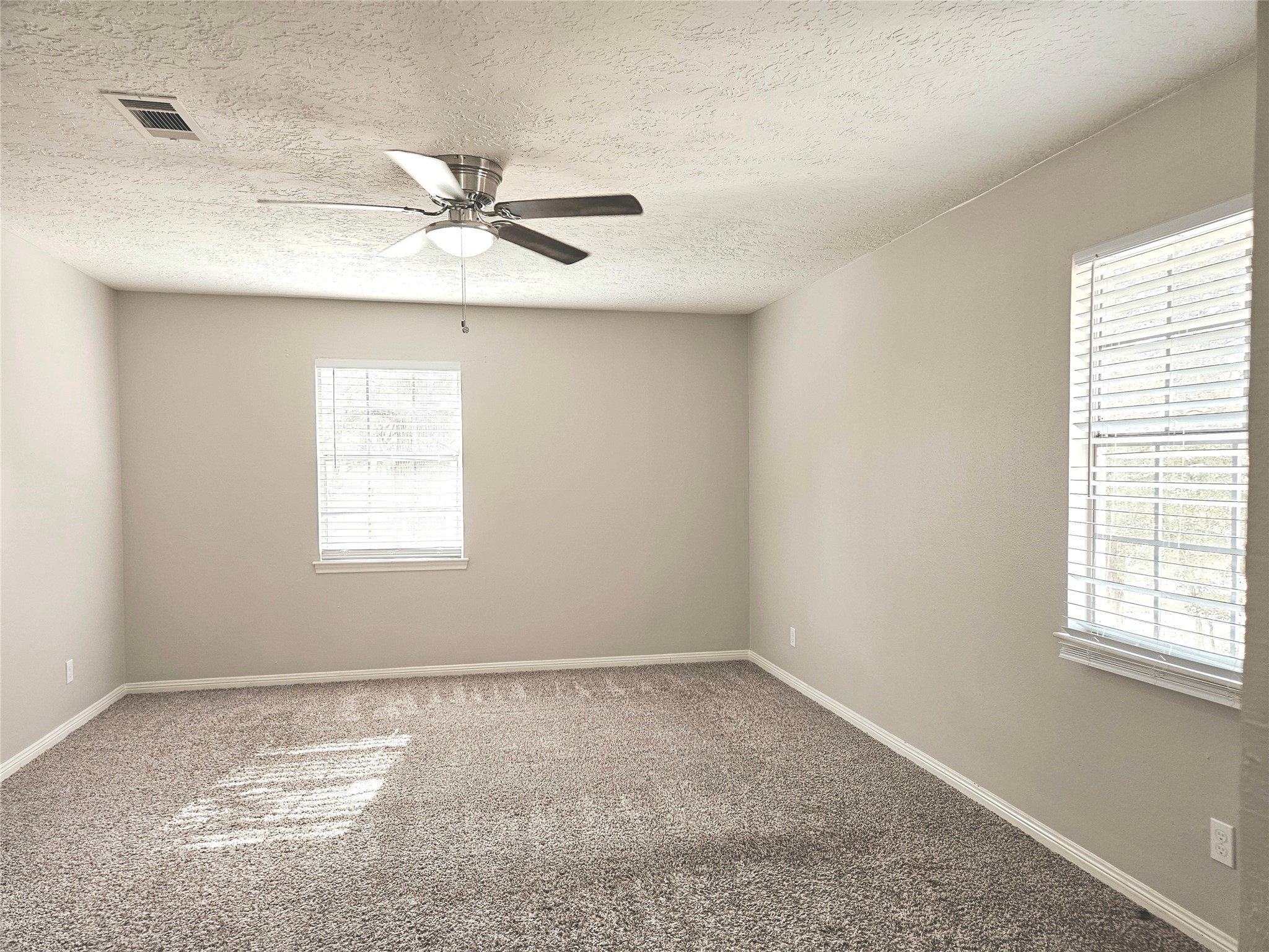 6126 Inway Drive Spring, TX 77389 - Photo 15 of 27 an empty room with a window and a fan