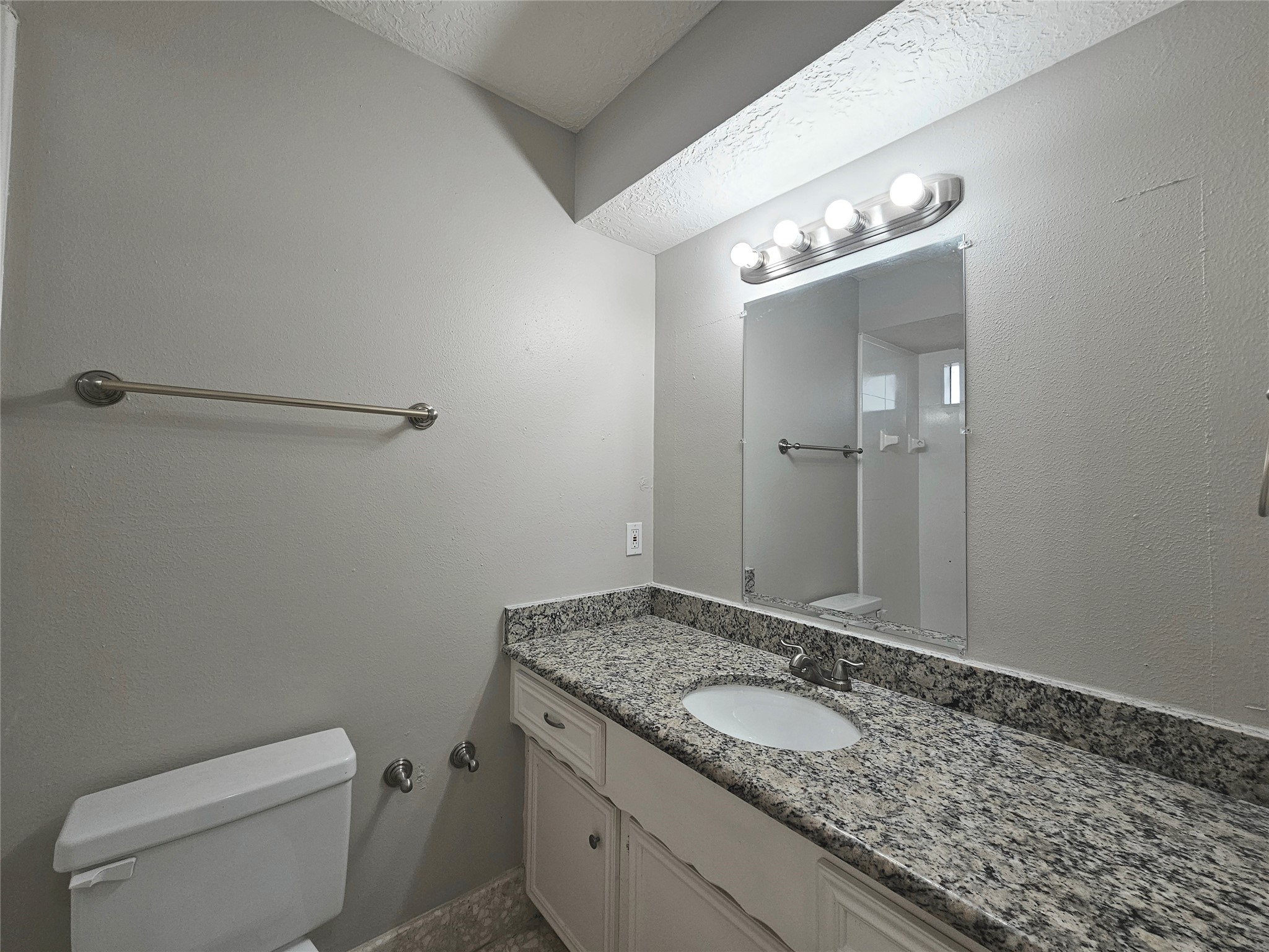 6126 Inway Drive Spring, TX 77389 - Photo 17 of 27 a bathroom with a granite countertop sink a toilet and mirror