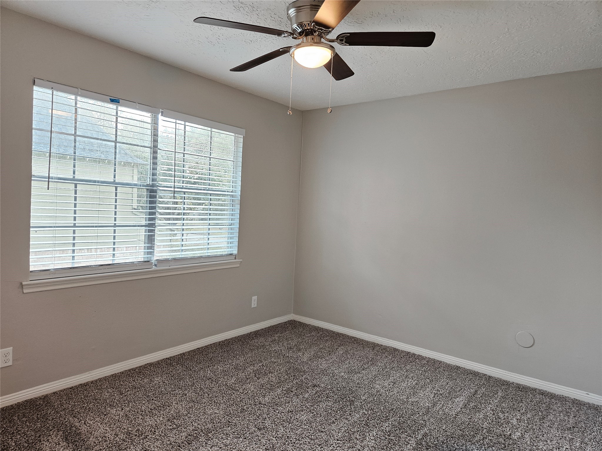 6126 Inway Drive Spring, TX 77389 - Photo 20 of 27 an empty room with a window and a fan