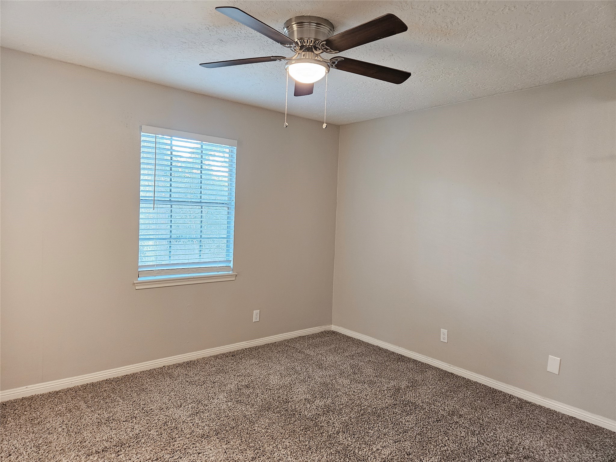 6126 Inway Drive Spring, TX 77389 - Photo 21 of 27 an empty room with a window and a fan