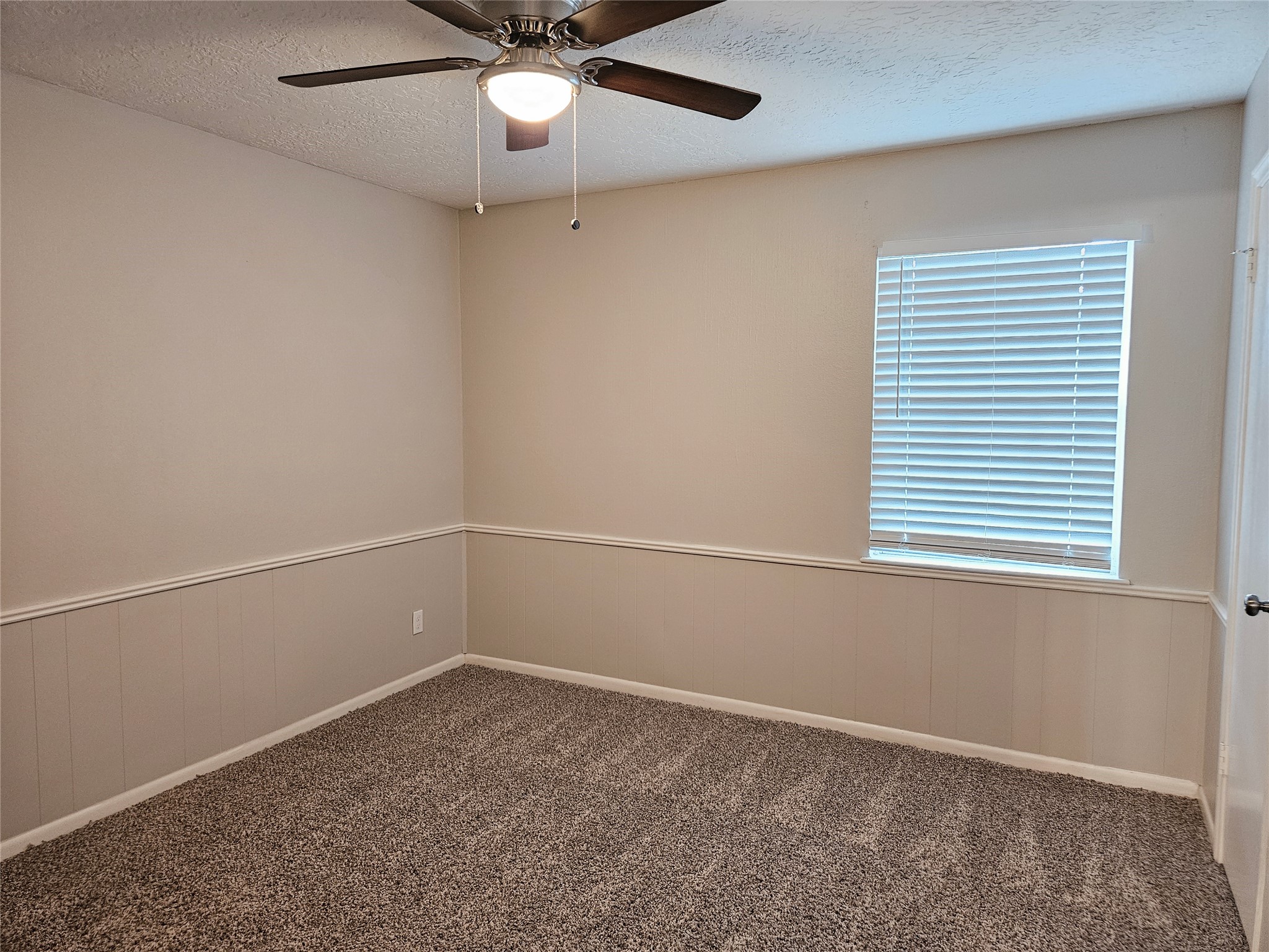 6126 Inway Drive Spring, TX 77389 - Photo 22 of 27 an empty room with a window and ceiling fan