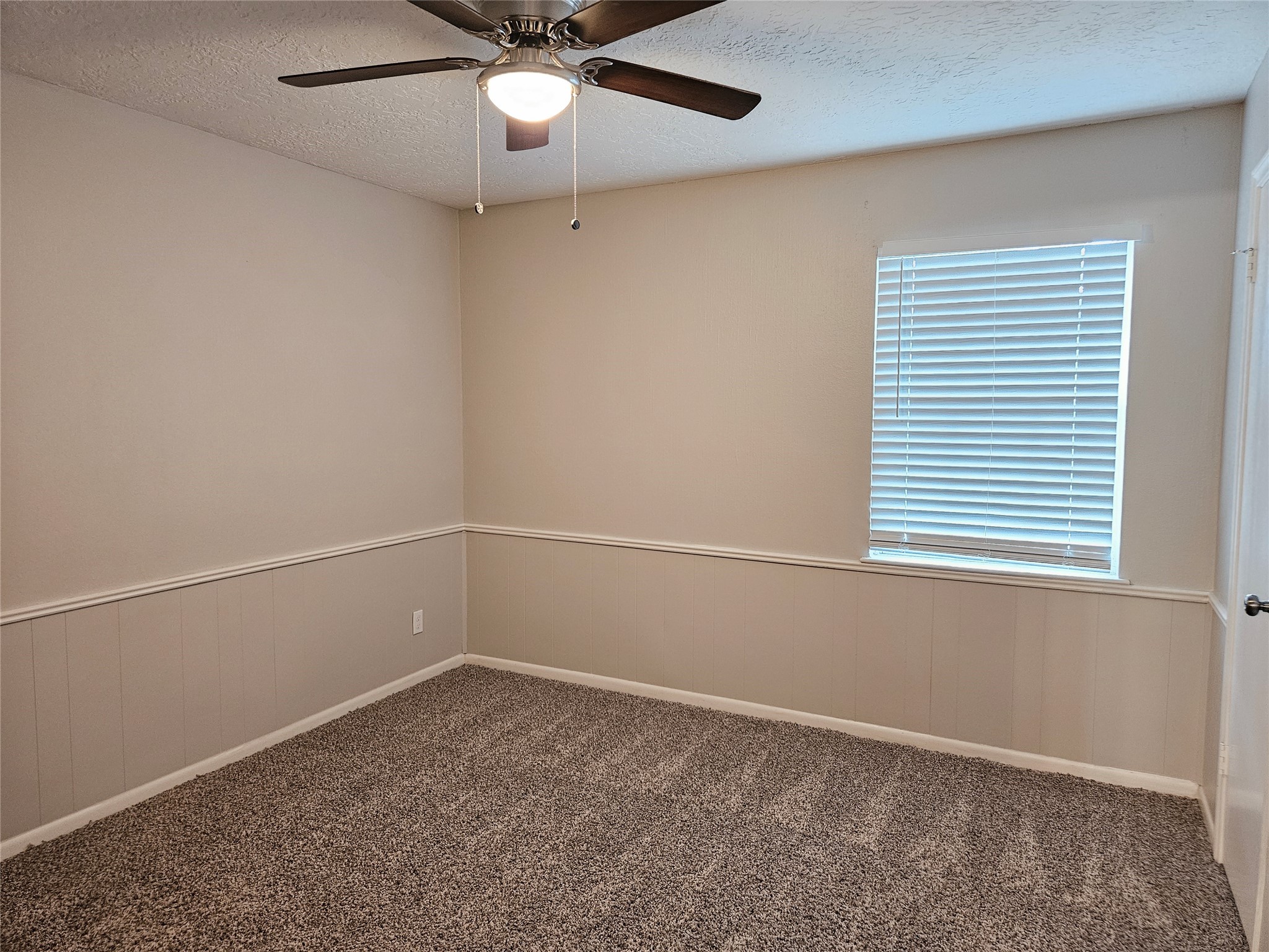 6126 Inway Drive Spring, TX 77389 - Photo 22 of 27 an empty room with a window and ceiling fan