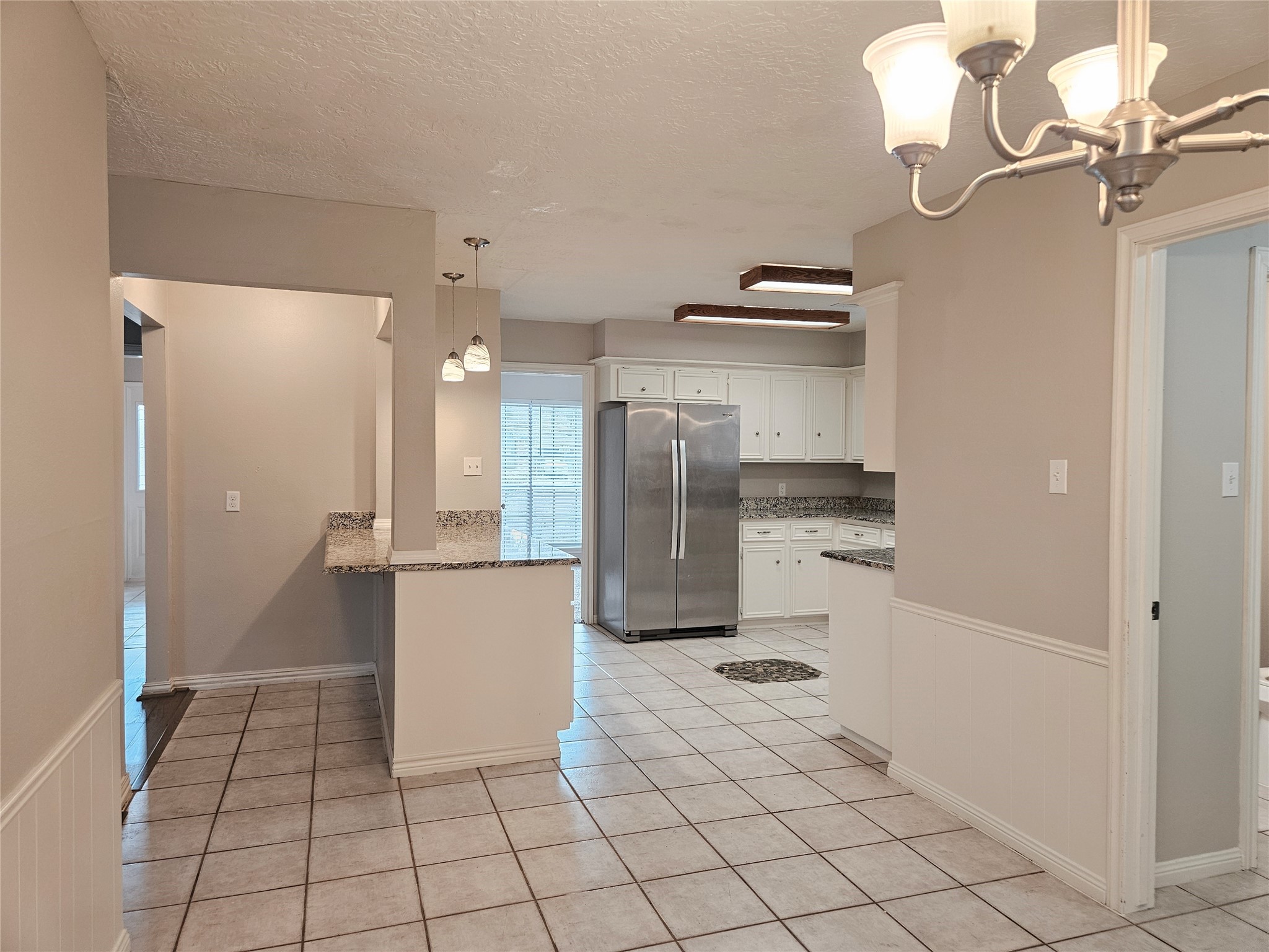 6126 Inway Drive Spring, TX 77389 - Photo 6 of 27 a kitchen with stainless steel appliances kitchen island granite countertop a refrigerator and a sink