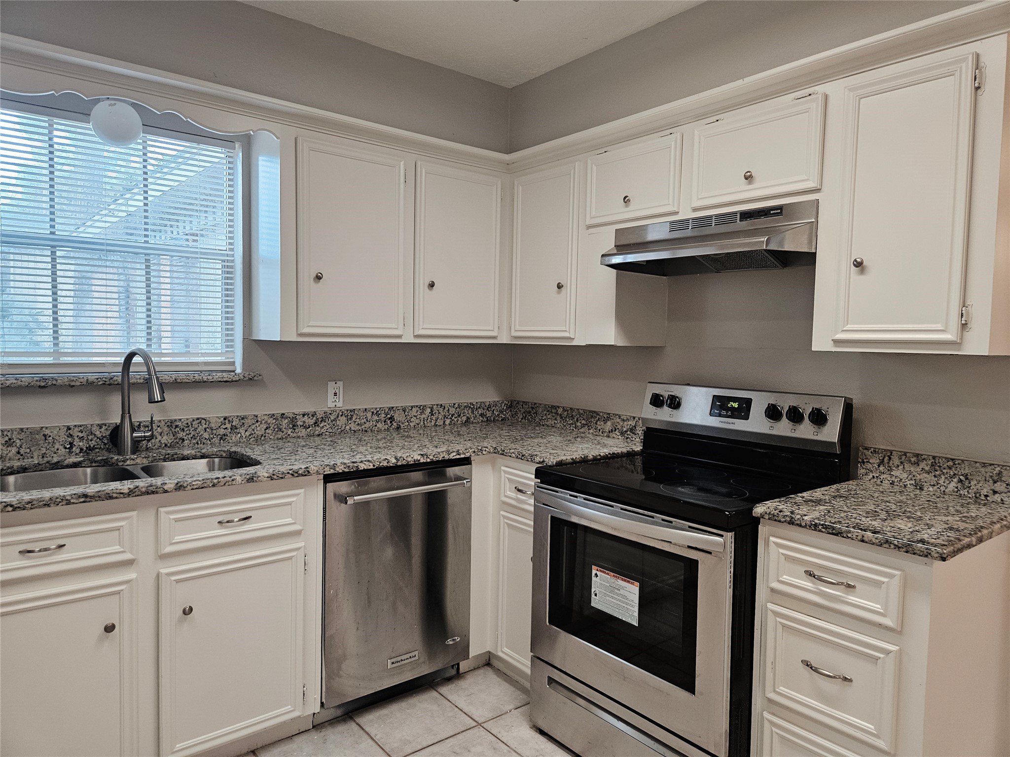 6126 Inway Drive Spring, TX 77389 - Photo 8 of 27 a kitchen with granite countertop white cabinets and stainless steel appliances