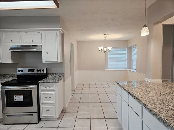 a kitchen with a stove and a sink