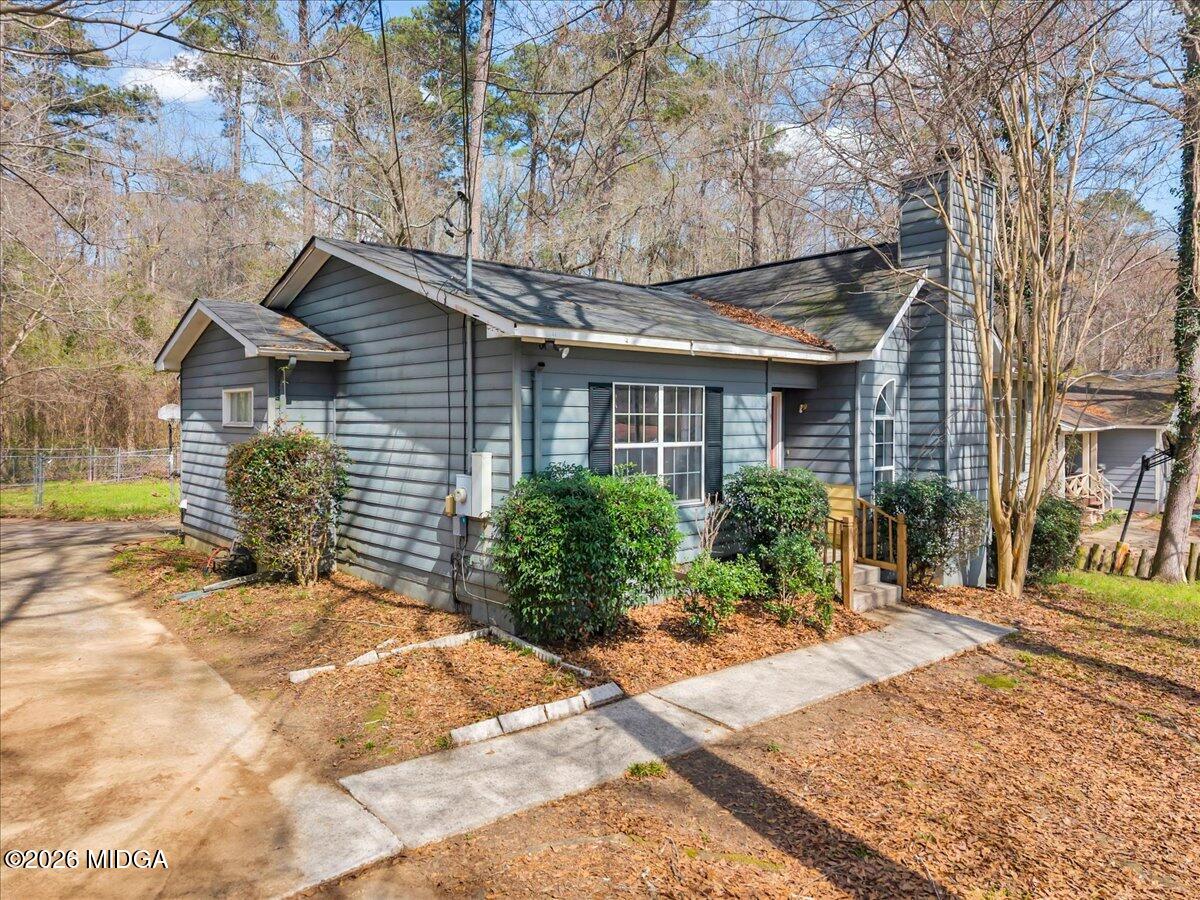 616 Will Scarlet Way Macon, GA 31220 - Photo 2 of 5 a front view of a house with a yard and potted plants