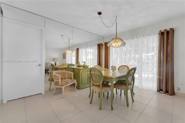 a view of a dining room with furniture and a chandelier