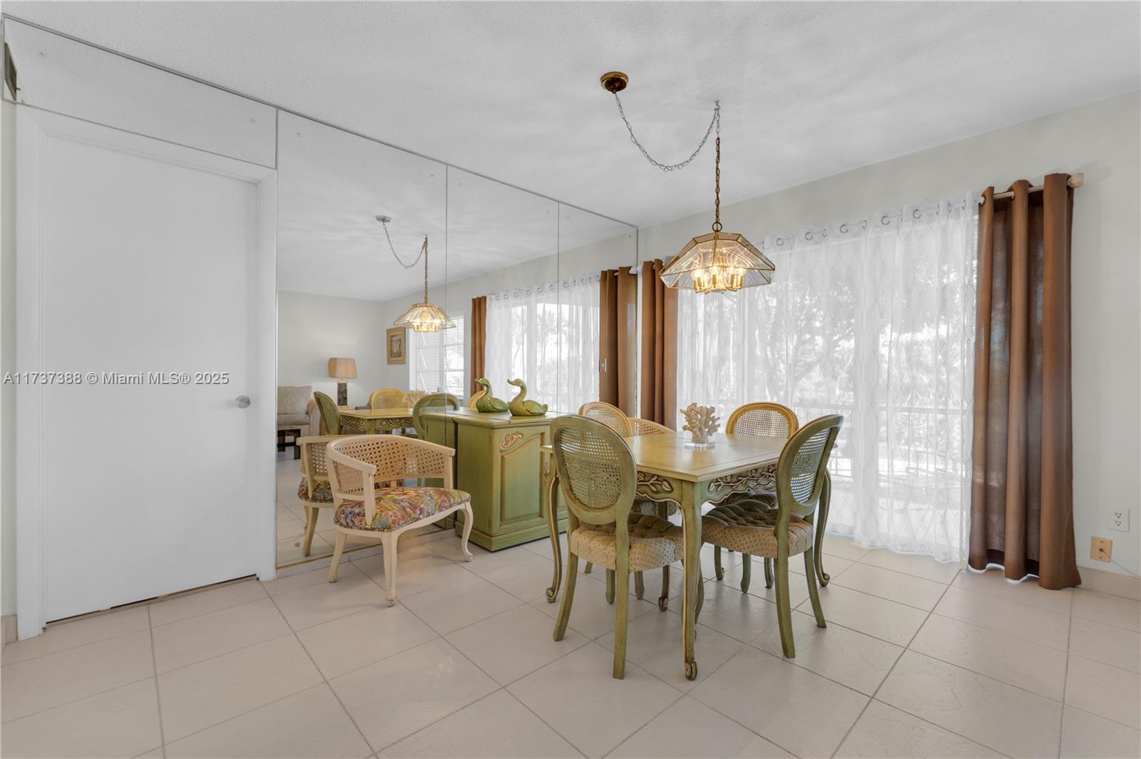 200 Diplomat Parkway, Unit 229 Hallandale Beach, FL 33009 - Photo 11 of 30 a view of a dining room with furniture and a chandelier