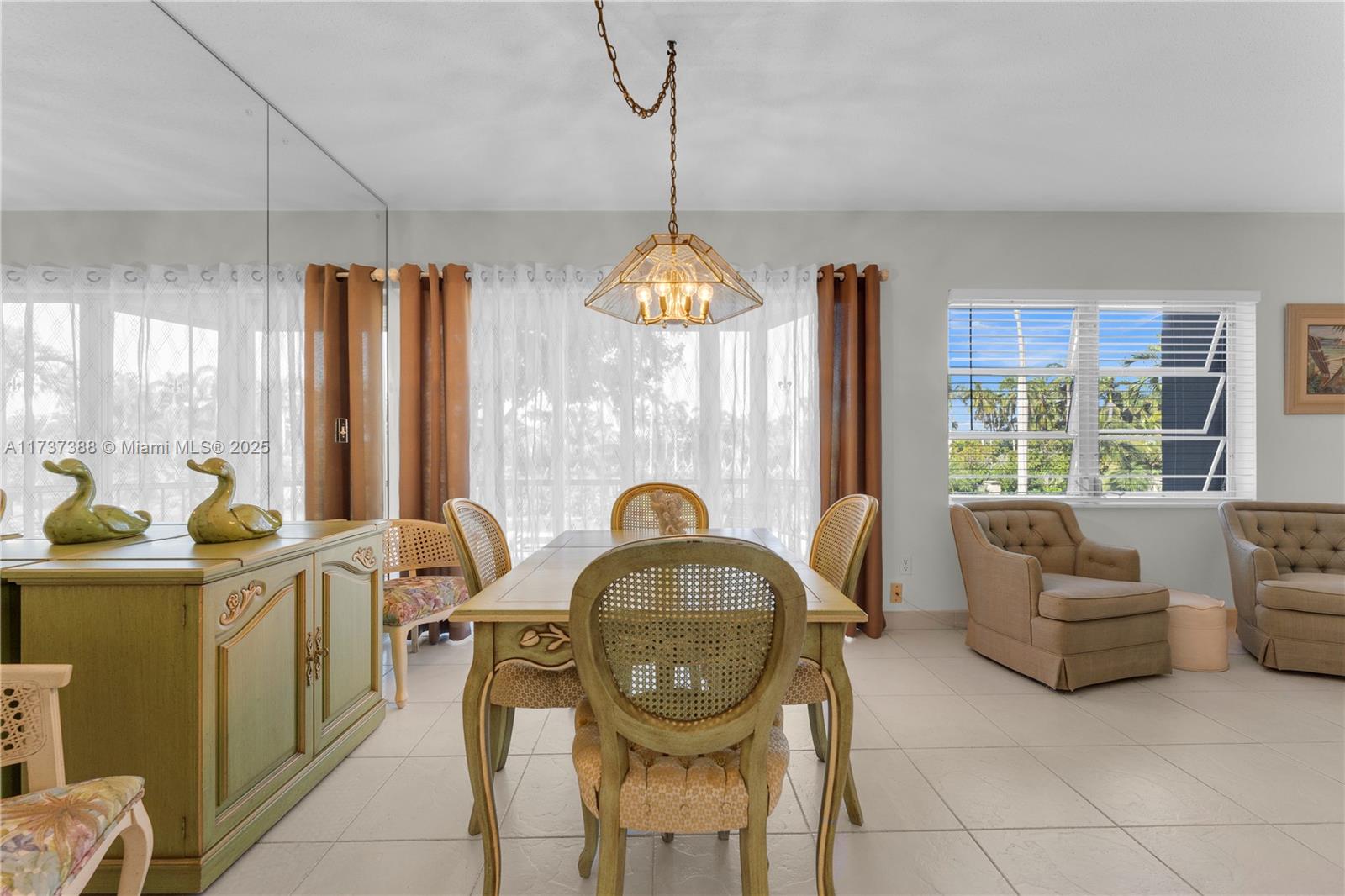 200 Diplomat Parkway, Unit 229 Hallandale Beach, FL 33009 - Photo 12 of 30 a view of a dining room with furniture window and outside view