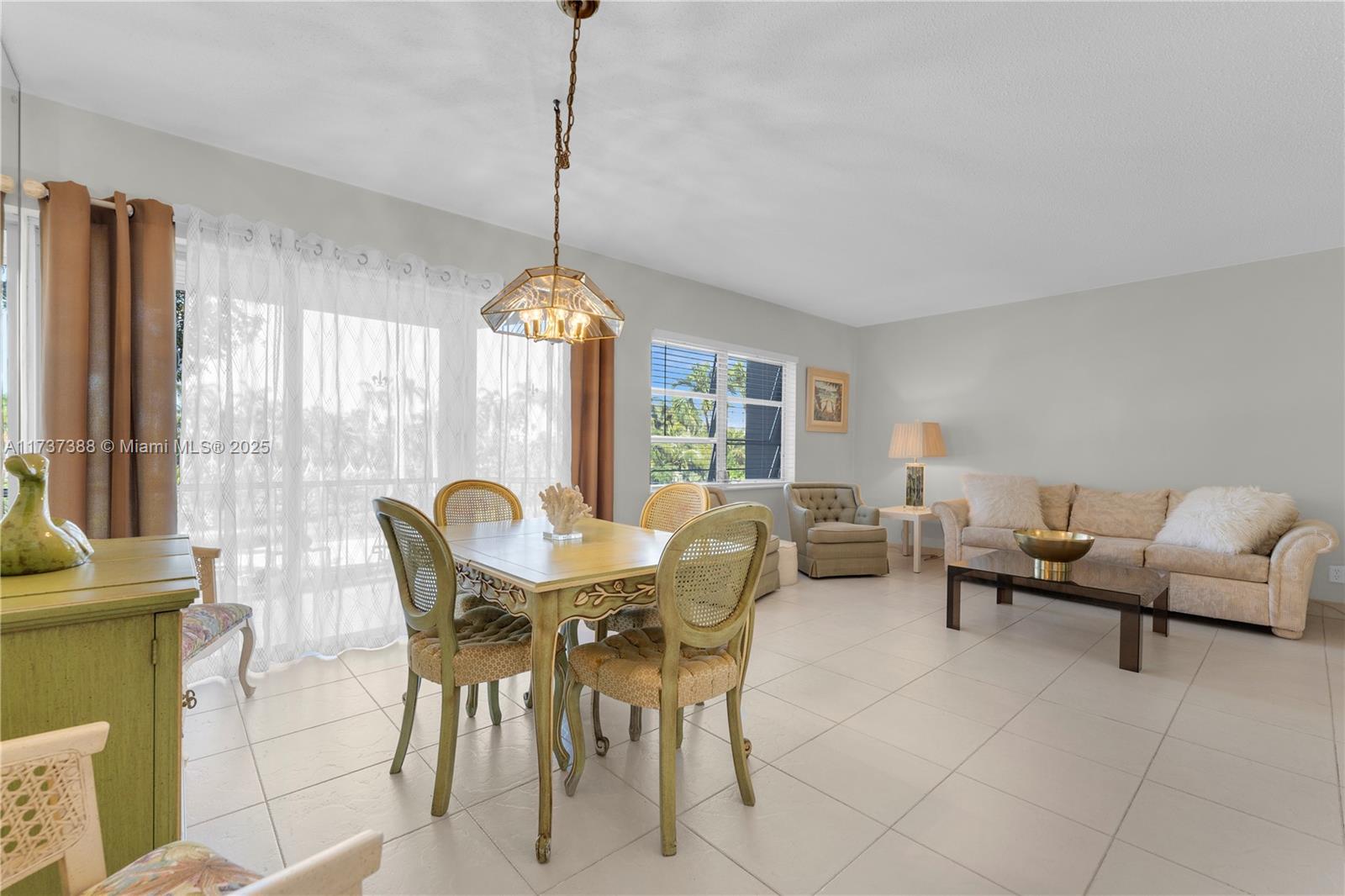 200 Diplomat Parkway, Unit 229 Hallandale Beach, FL 33009 - Photo 2 of 30 a view of a dining room with furniture window and outside view