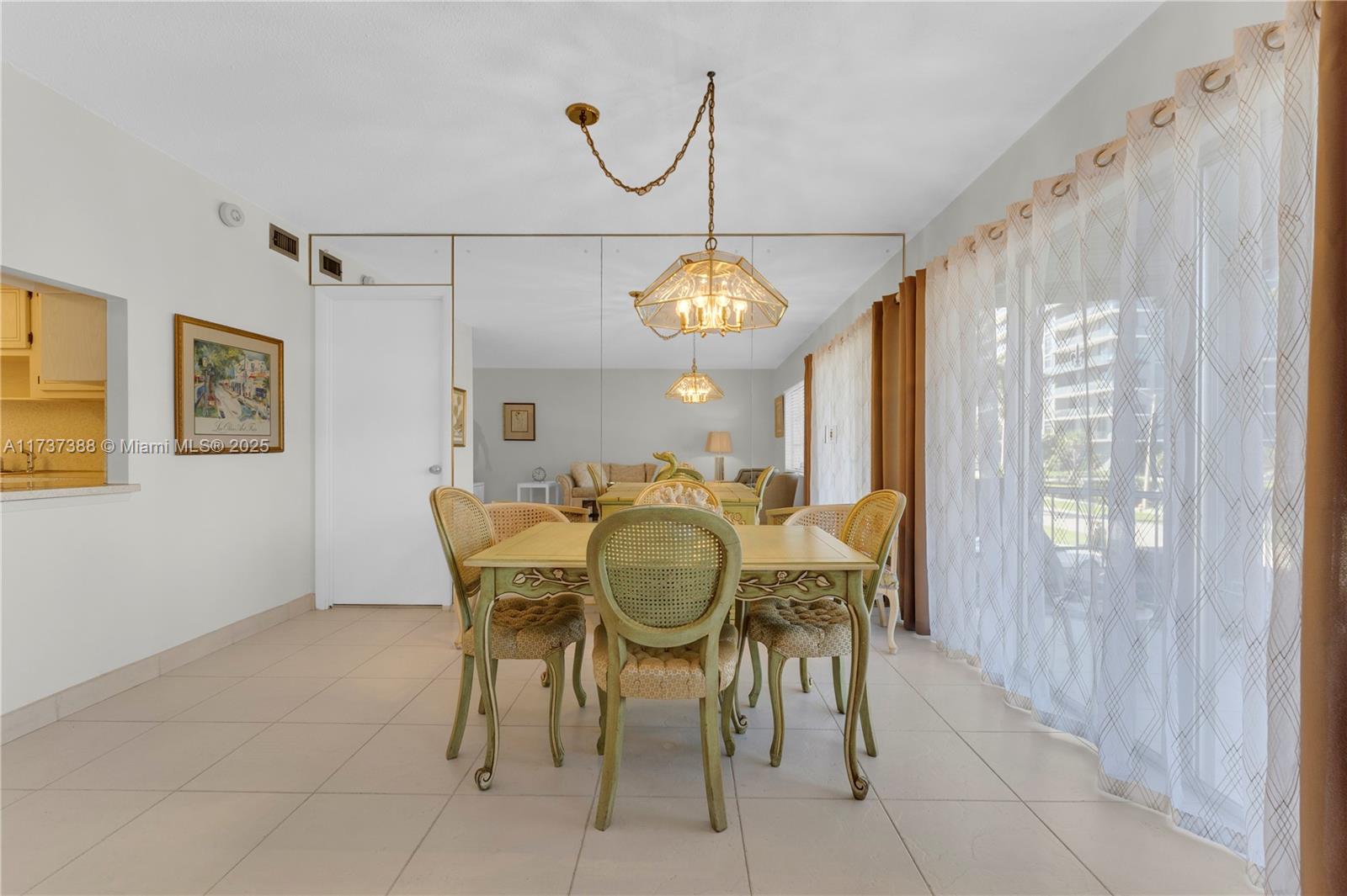 200 Diplomat Parkway, Unit 229 Hallandale Beach, FL 33009 - Photo 4 of 30 a dining room with furniture a chandelier and a rug