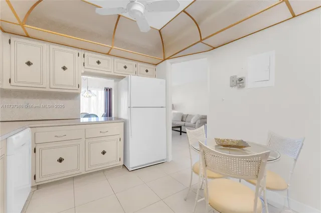 a kitchen with a refrigerator and cabinets