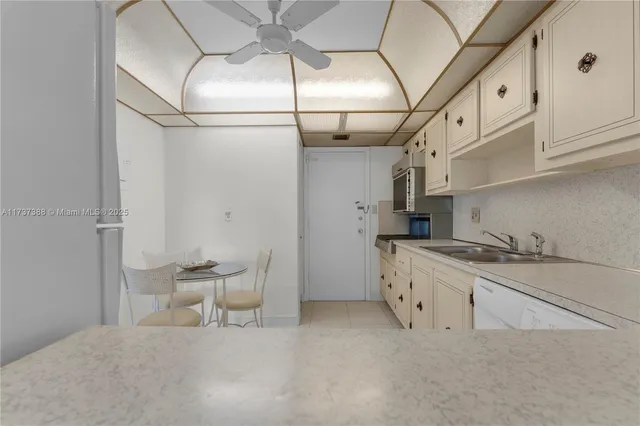 a kitchen with stainless steel appliances granite countertop a sink and cabinets