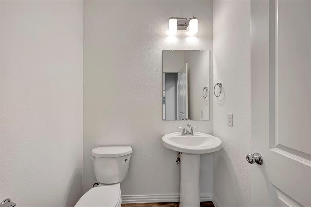 3704 Water Lily Way Prosper, TX 75078 - Photo 15 of 40 a bathroom with a toilet sink and mirror