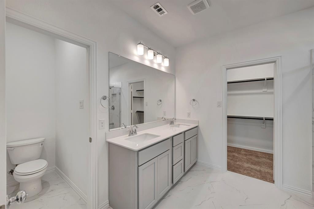 3704 Water Lily Way Prosper, TX 75078 - Photo 22 of 40 a spacious bathroom with a toilet sink and mirror