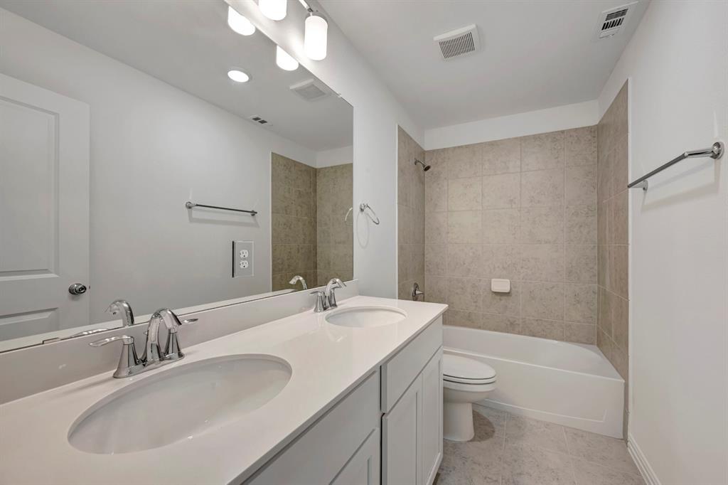 3704 Water Lily Way Prosper, TX 75078 - Photo 26 of 40 a bathroom with a double vanity sink toilet mirror and bathtub