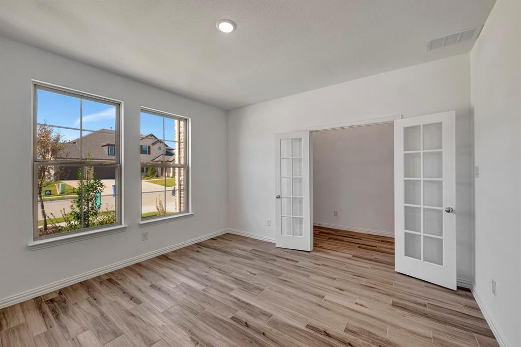 3704 Water Lily Way Prosper, TX 75078 - Photo 7 of 40 an empty room with wooden floor and windows