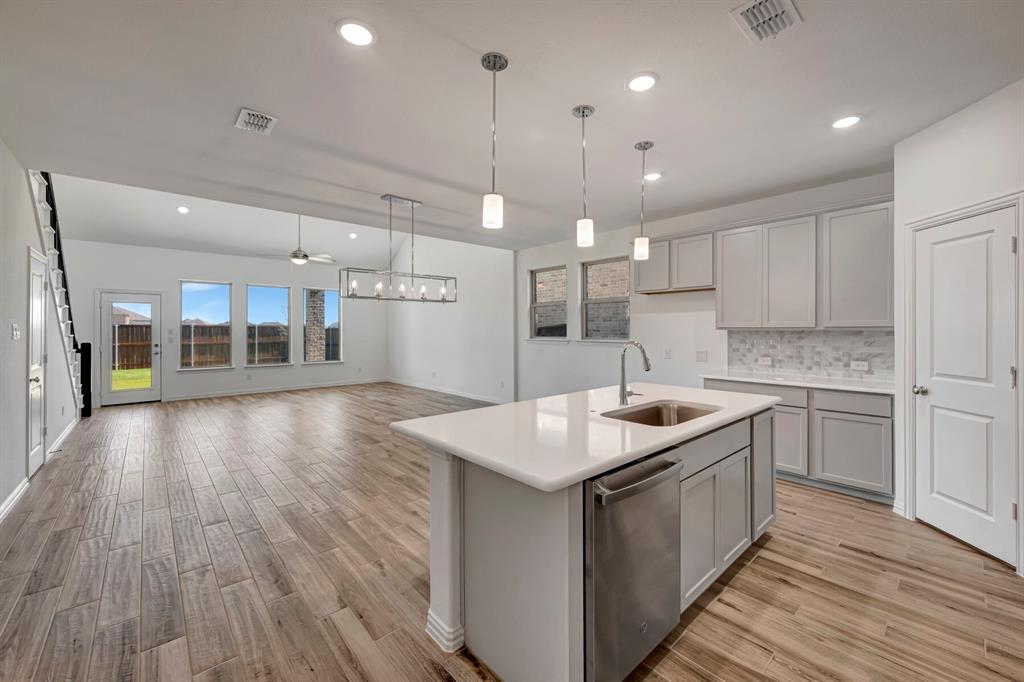3704 Water Lily Way Prosper, TX 75078 - Photo 9 of 40 a kitchen with a sink and stove top oven
