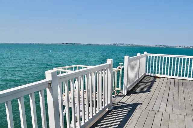 a balcony with wooden floor and fence