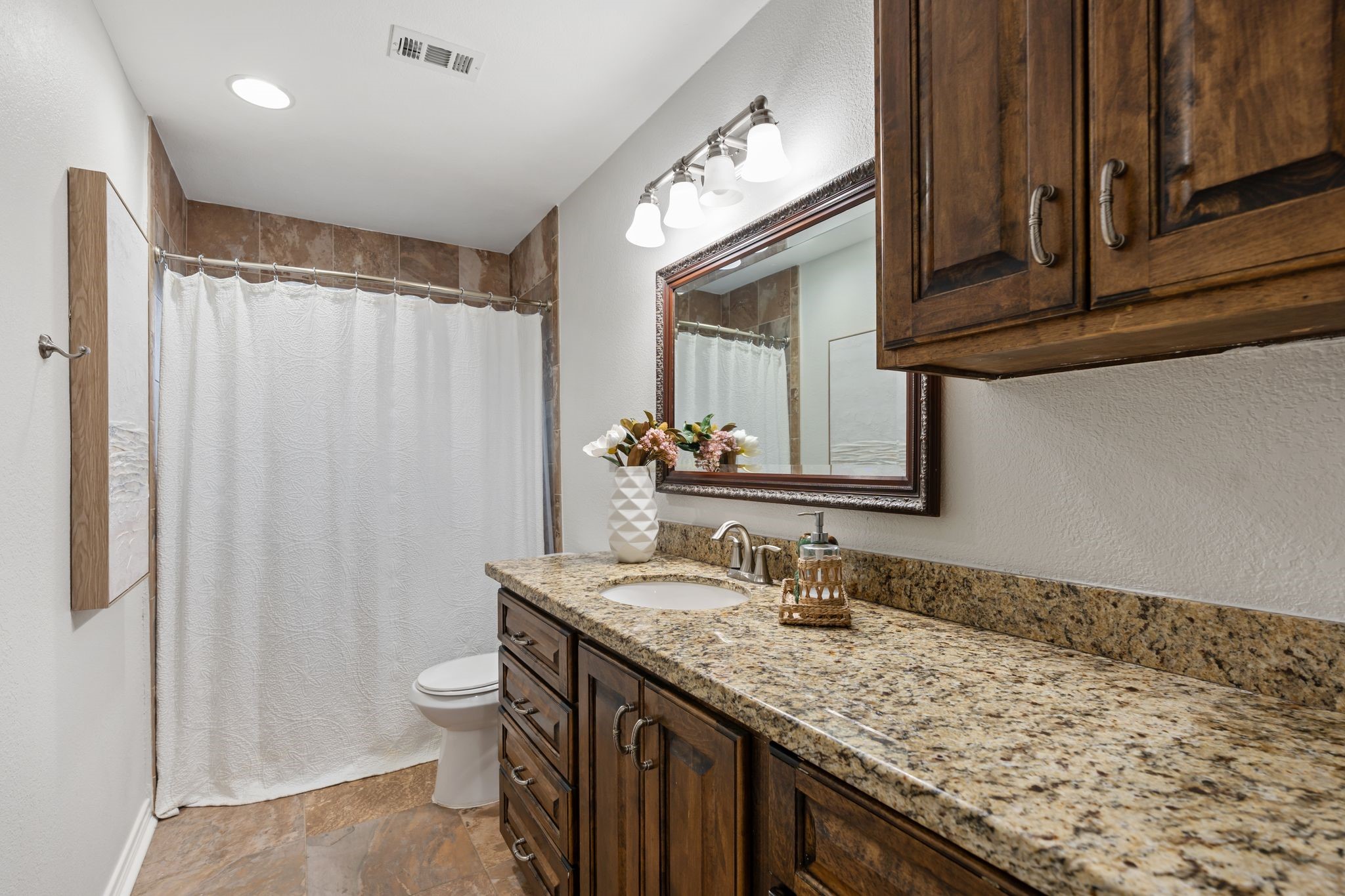 5658 Cartagena Street Houston, TX 77035 - Photo 20 of 33 This hall bathroom serves the 2 secondary bedrooms. Granite counters and ample storage.
