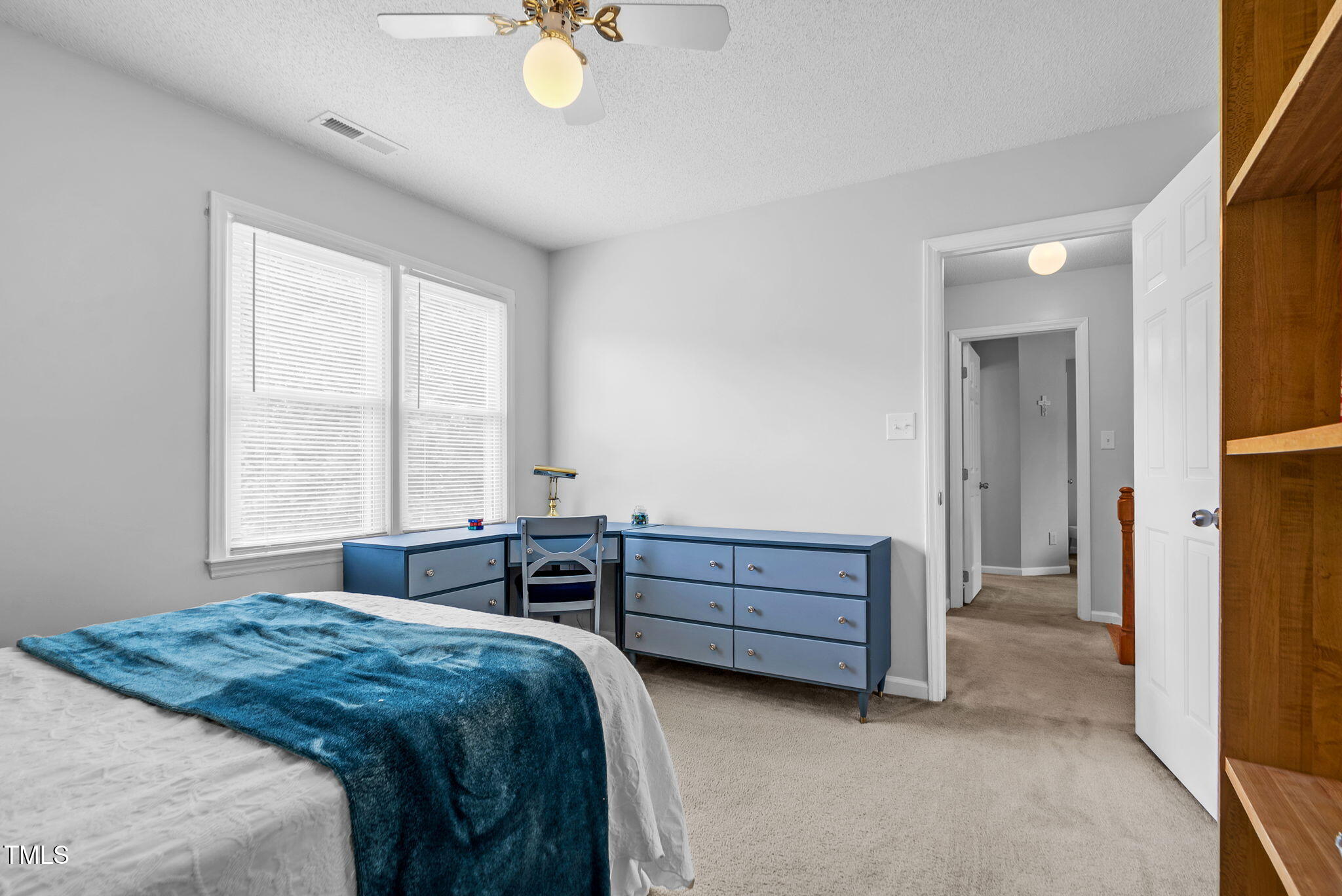 209 Bradley Drive Benson, NC 27504 - Photo 13 of 20 a bedroom with a bed and a chandelier