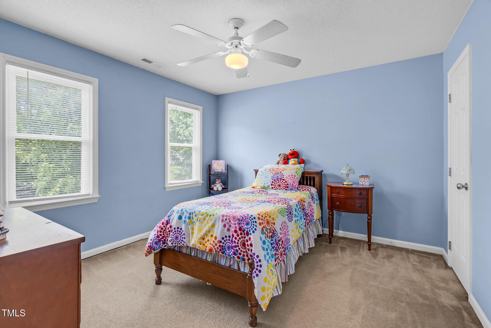 209 Bradley Drive Benson, NC 27504 - Photo 14 of 20 a bedroom with a bed and a chandelier fan